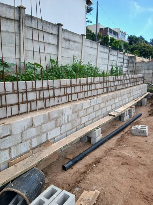 Steel reinforcement visible between the masonry skins during wall construction.