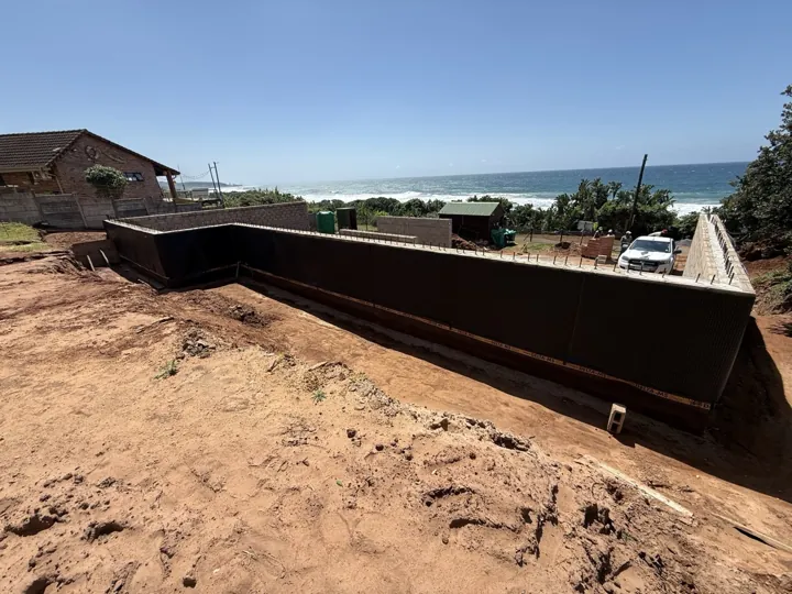 Long wall at the Mtwalume site with surrounding ground still exposed.