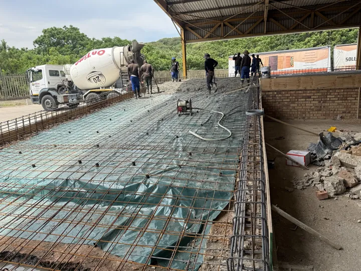 Concrete being placed over the reinforced slab at the dock leveller platform.